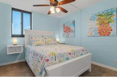 a bedroom with a bed and a ceiling fan at Ocean Front Beach Condo in Panama City Beach