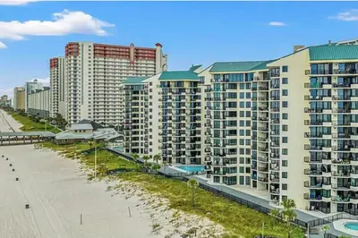 a view of a beach with tall buildings at Ocean Front Beach Condo in Panama City Beach