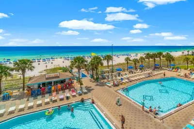 an overhead view of a pool at a resort with a beach at The Summit 828 in Panama City Beach