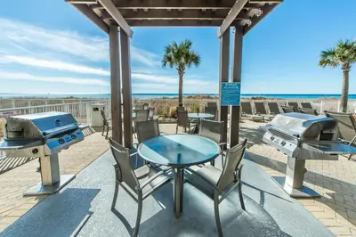 a patio with a table and two bbq and grill at Ocean Villa 1803 in Panama City Beach