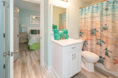 a bathroom with a sink and a toilet and a shower at Sugar Shores OR in Panama City Beach