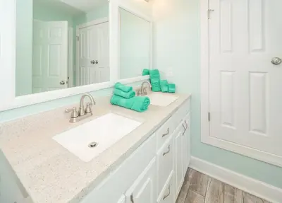a bathroom with two sinks and a large mirror at Sugar Shores OR in Panama City Beach