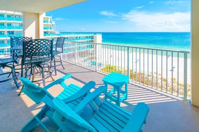 a balcony with blue beach chairs and the ocean at Sugar Shores OR in Panama City Beach