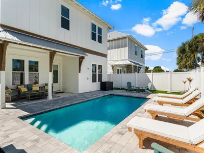a swimming pool in the backyard of a house at Sugar Sand Sunset in Panama City Beach