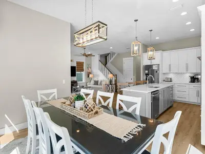 a kitchen and dining room with a table and chairs at Sugar Sand Sunset in Panama City Beach
