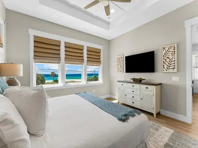 a bedroom with a bed and a flat screen tv at Sugar Sand Sunset in Panama City Beach
