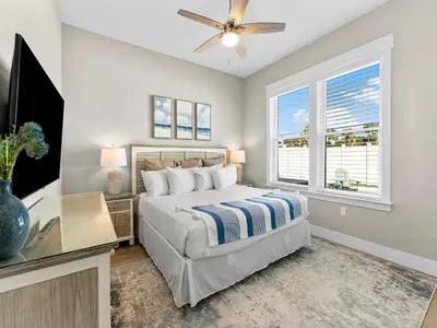 a bedroom with a bed and a flat screen tv at Sugar Sand Sunset in Panama City Beach