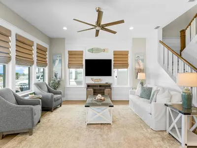 a living room with a couch and a tv at Sugar Sand Sunset in Panama City Beach