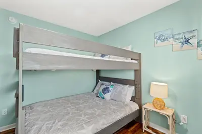 a bedroom with two bunk beds and a lamp at Panama City Beach Oasis in Panama City Beach