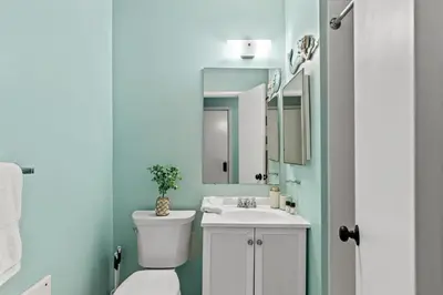 a bathroom with a toilet and a sink and a mirror at Panama City Beach Oasis in Panama City Beach
