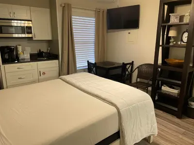 a bedroom with a bed and a kitchen with a table at St Thomas Square #1204C in Panama City Beach