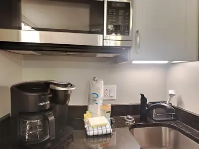a kitchen counter with a coffee maker and a microwave at St Thomas Square #1204C in Panama City Beach