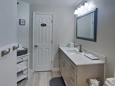 a white bathroom with a sink and a mirror at St Thomas Square #1204C in Panama City Beach