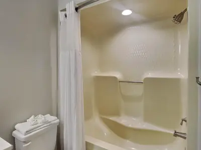 a white bathroom with a shower and a toilet at St Thomas Square #1204C in Panama City Beach