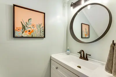 a bathroom with a sink and a mirror at Resort-Style PCB Townhome Beach Access and Pools! in Panama City Beach