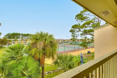a view of a tennis court from a balcony at Resort-Style PCB Townhome Beach Access and Pools! in Panama City Beach