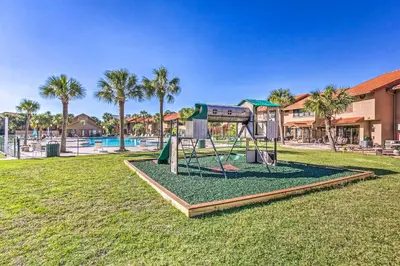a playground in a park next to a pool at Resort-Style PCB Townhome Beach Access and Pools! in Panama City Beach