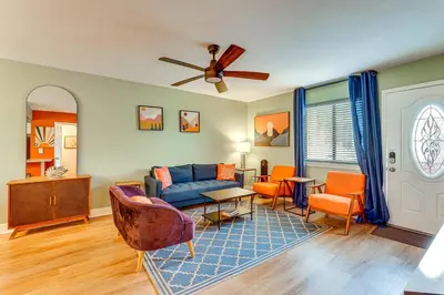 a living room with a blue couch and chairs at Resort-Style PCB Townhome Beach Access and Pools! in Panama City Beach