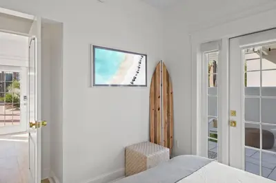 a white bedroom with a bed and a mirror at 30A Beach Villa Steps to Beach Dog Friendly with Peloton and Bikes in Rosemary Beach