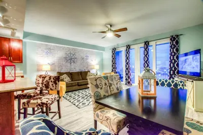 a living room with a couch and a table at Laketown Wharf 1135 NEW in Panama City Beach