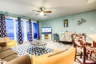 a living room with a couch and a tv at Laketown Wharf 1135 NEW in Panama City Beach