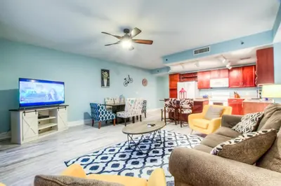 a living room with two couches and a kitchen at Laketown Wharf 1135 NEW in Panama City Beach