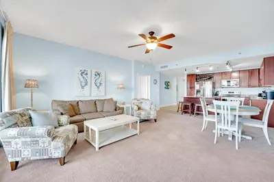 a living room with a couch and a table at The Blue Turtle Laketown in Panama City Beach