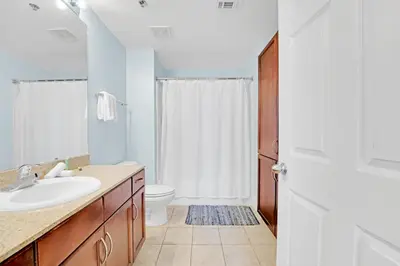 a bathroom with a sink and a toilet at The Blue Turtle Laketown in Panama City Beach