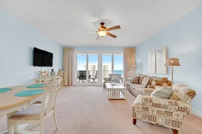 a living room with a table and a dining room at The Blue Turtle Laketown in Panama City Beach