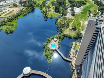 an aerial view of a golf course in the water next to a building at The Blue Turtle Laketown in Panama City Beach