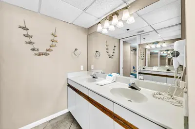 a bathroom with a sink and a mirror at Edgewater Tower 3-1104 in Panama City Beach