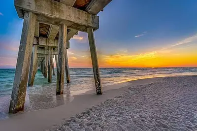 a pier on the beach with the ocean at Sunset Breeze in Panama City Beach