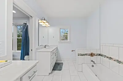 a white bathroom with two sinks and a bath tub at 30A | Pool | Sunnyside Up | Walk to Beach| Golf Cart | Seagrove in Santa Rosa Beach