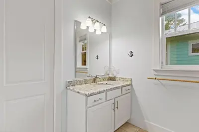 a white bathroom with a sink and a mirror at 30A | Pool | Sunnyside Up | Walk to Beach| Golf Cart | Seagrove in Santa Rosa Beach