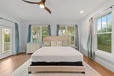 a bedroom with a bed and a ceiling fan at 30A | Pool | Sunnyside Up | Walk to Beach| Golf Cart | Seagrove in Santa Rosa Beach