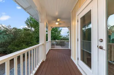 a front porch of a home with a wooden deck at 30A | Pool | Sunnyside Up | Walk to Beach| Golf Cart | Seagrove in Santa Rosa Beach