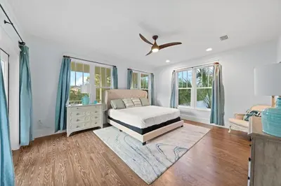 a bedroom with a bed and a dresser and windows at 30A | Pool | Sunnyside Up | Walk to Beach| Golf Cart | Seagrove in Santa Rosa Beach