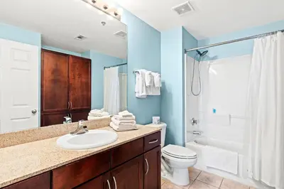 a bathroom with a sink and a toilet and a shower at Blue Turtle at Laketown in Panama City Beach