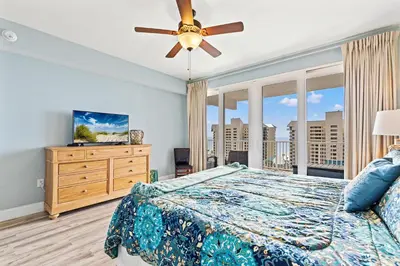 a bedroom with a bed and a ceiling fan at Blue Turtle at Laketown in Panama City Beach