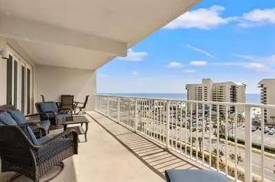 a balcony with chairs and a view of the ocean at Blue Turtle at Laketown in Panama City Beach