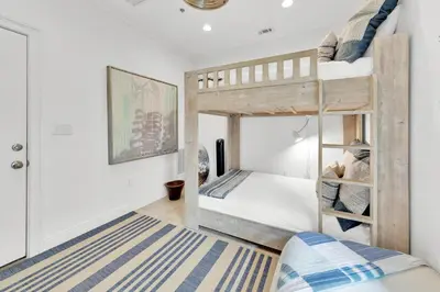 a small bedroom with a bunk bed and a rug at Legacy 502 - Abalone in Santa Rosa Beach
