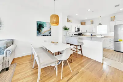 a kitchen and living room with a table and chairs at Legacy 502 - Abalone in Santa Rosa Beach
