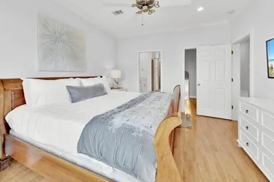 a white bedroom with a large bed and a dresser at Legacy 502 - Abalone in Santa Rosa Beach