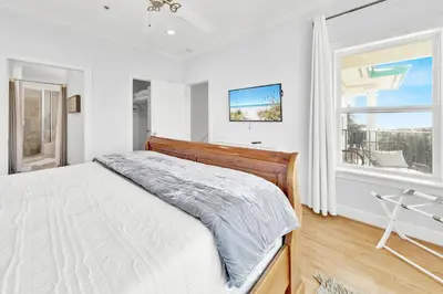 a white bedroom with a bed and a window at Legacy 502 - Abalone in Santa Rosa Beach