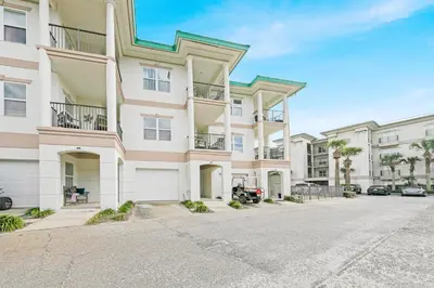 a large apartment building with a parking lot at Legacy 502 - Abalone in Santa Rosa Beach