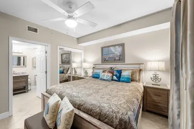 a bedroom with a bed and a ceiling fan at Beachfront Retreat! Family Friendly 1BD Getaway! by Dolce Vita Getaways PCB! in Panama City Beach