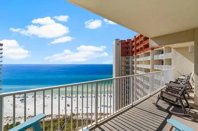 a balcony with chairs and a view of the beach at Beachfront Retreat! Spacious Resort Condo with Great Views! by Dolce Vita Getaways PCB! in Panama City Beach