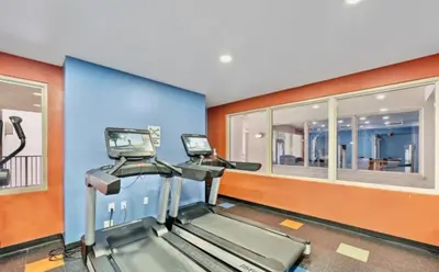 a gym with two treadmills in a room at Beachfront Retreat! Spacious Resort Condo with Great Views! by Dolce Vita Getaways PCB! in Panama City Beach