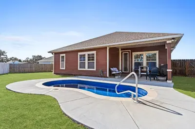 a house with a swimming pool in the yard at Family Tides II in Panama City Beach