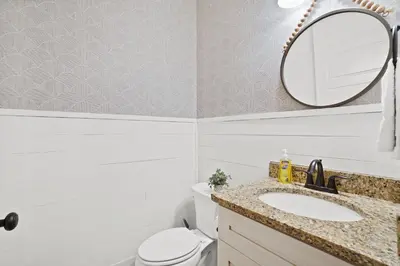 a bathroom with a sink and a mirror at Family Tides II in Panama City Beach